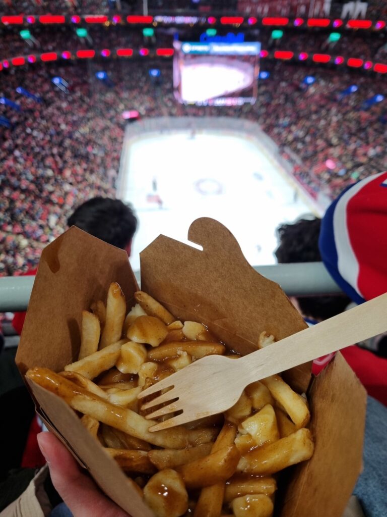 Eating poutine at Center Bell during a hockey game
