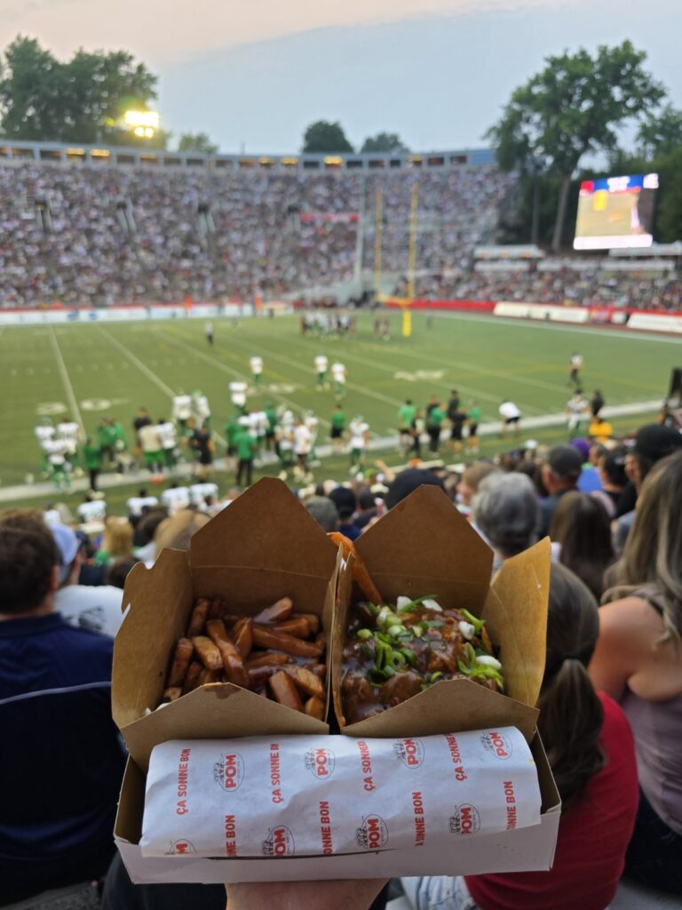 Eating poutine at Percival Molson stadium during a football game